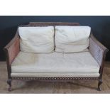 Antique Mahogany Framed Rattan Sofa. Pierced and carved decoration, standing on hoof feet