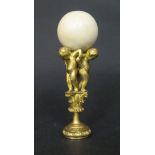 A Fine 19th Century Gilt Bronze and Ivory Mounted Seal formed as three putti bearing an ivory ball