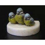 A Cold Painted Bronze Group modelled as three blue tits on a soapstone base, 8wm wide