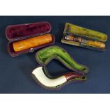 Three Cheroot Holders (two cased, on silver banded one 9ct gold collar) and cased Meerschaum pipe