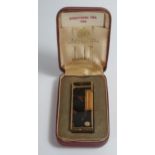 A Cased DUNHILL Rollagas Gold Plated and Brown Marble Lighter. Strikes, no gas