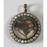 An Antique Pearl Mounted Memorial Locket with hinged panel, 26mm diam.