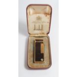 A Cased DUNHILL Rollagas Gold Plated and Red Marble Enamel Lighter. Strikes and lights