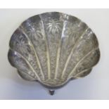 An Indian White Metal Scallop Shaped Dish with chased palm tree and foliate decoration