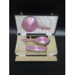 A Cased George V Silver and Pink Guilloché Enamel Four Part Hand Mirror and Brush Set, Birmingham