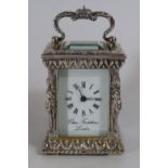 A Charles Frodsham Ornate London Silver and Gilt Cased Miniature Carriage Clock decorated with