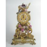 A French 19th Century Gilt Metal Mantle Clock with applied ceramic flower decoration, striking
