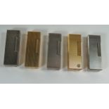 Three Dunhill Rollagas Silver Plated Lighters and two gold plated. None with flints