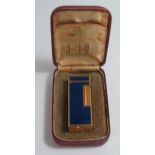 A Cased DUNHILL Rollagas Gold Plated and Blue Marble Enamel Lighter. No flint