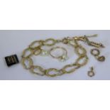 A 9ct Gold Horseshoe Bracelet (10.3g with loose link), a 9ct gold three pearl ring (size Q, 1.9g),