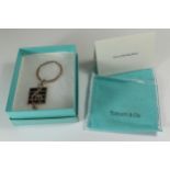 An Tiffany & Co. Silver and Enamel Musical Cleff Keyring in original packaging