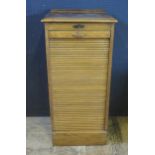 An Oak Tambour Fronted Filing Cabinet with nine slides, 48(w)x103(h)x41(d)cm