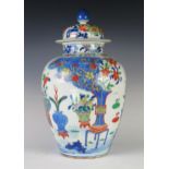 An Antique Chinese Wucai Porcelain Vase with Cover decorated with vases, prunus, ferns and other