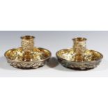 A Sterling Silver Twin Candlestick Travelling Set with embossed foliate scroll decoration and gilt