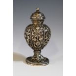 An Antique Unmarked Indian Silver Pepper with foliate embossed hexagonal body with screw on lid,