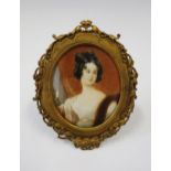 An Early 19th Century Portrait Miniature of a Lady in an easel back gilt metal frame, 12 x 9.5 cm