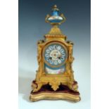 A 19th Century French Gilt Metal Mantle Clock with Sevres Panels and on a gilt wood base, striking