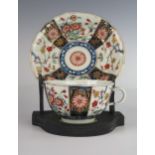 An 18th Century Worcester Dr. Wall Period Shaped Teacup and Saucer decorated in the Imari palette