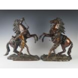 A Pair of French Bronze Marly Horses, bases signed Coustou, 45 cm high, bases 33.5 cm