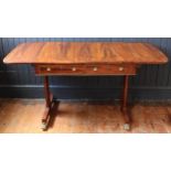 A Regency Rosewood and Crossbanded Drop Leaf Sofa Table with stretched hexagonal twin supports