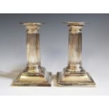 A Pair of Edward VII Silver Candlesticks with reeded columns and detachable sconces, Sheffield 1905,