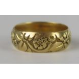 A Victorian 18ct Gold Floral Decorated Wedding Band, 17mm wide, size R, 7.4g, London 1859, maker W.