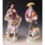 A Pair of 19th Century Volkstedt Porcelain Figurines of a Male Pipe Player and Female Flower Seller,