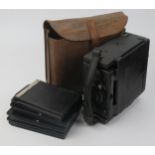 An Ensign Folding Reflex Camera in case and with four plate slides