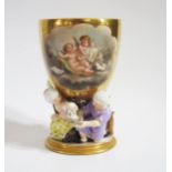 A Rare 18th Century German Porcelain Goblet, the gilt bowl decorated with a cartouche of Putti and