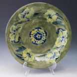 A William Moorcroft Green Ground Floral Decorated Shallow Bowl, signed and impressed marks, 28cm