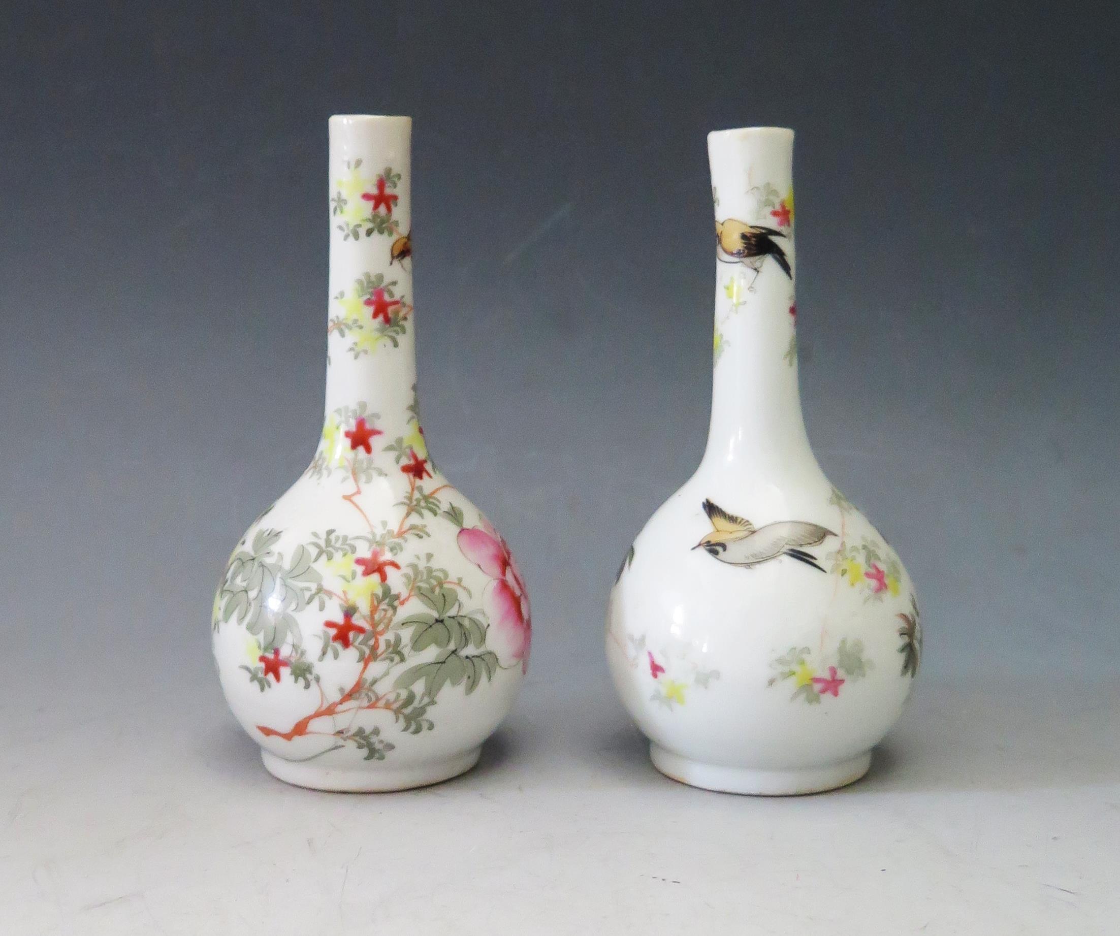 A Pair of Antique Japanese Porcelain Pinch Neck Vases with foliate and bird decoration, marks to