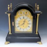 An English Triple Fusee Mantle Clock in an ebonised case and quarter striking to eight bells with
