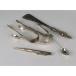 Three Silver Sugar Tongs, silver handled shoe horn, silver Yard o Led, etc.