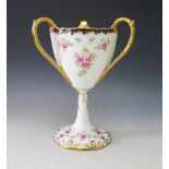 A Wedgwood Tyg Vase hand painmted with roses with a royal blue rim and gilt highlights, 22cm