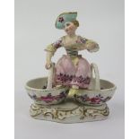 An 18th Century Meissen Porcelain Figure of a Lady Seated on Two Baskets, underglaze mark to base,