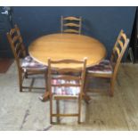 An Ercol Extending Single Pedestal Dining Table and Four Chairs