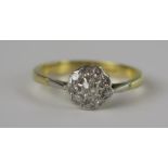 An 18ct Gold and Diamond Ten Stone Cluster Ring, central stone c. 3mm, 8.5mm head, size R.75, 3.6g