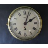 A Ship's Brass Bulkhead Clock, possibly by Elliot, 7" dial. Running