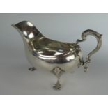 A Georgian Silver Sauceboat with scalloped feet, London 1768, maker *M, 18cm long, 248g