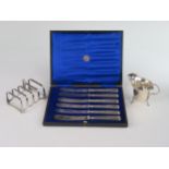 A George V Silver Four Slot Toast Rack (Birmingham 1929, W.D), silver creamer (Birmingham 1929, C&