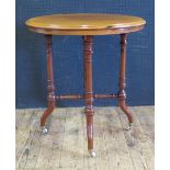 A Victorian Mahogany Occasional Table with white porcelain castors, 58cm diam. x 63(h) cm