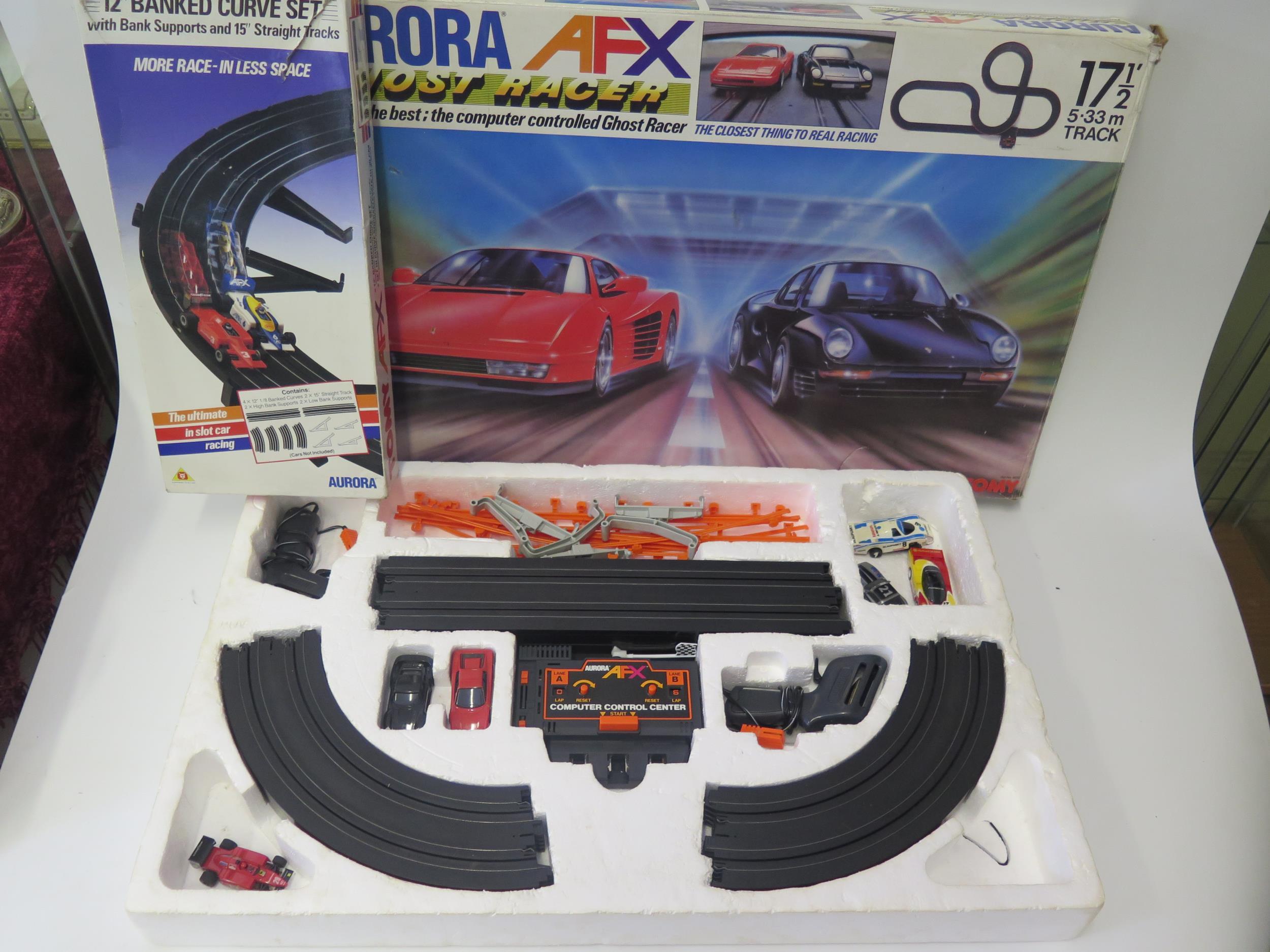 An Auroa AFX by Tomy Ghost Racer Slot Car Set Boxed with extra cars and track