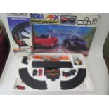 An Auroa AFX by Tomy Ghost Racer Slot Car Set Boxed with extra cars and track