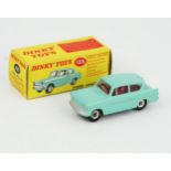 A Dinky Toys 155 Ford Anglia in turquoise with red interior and spun hubs. Near mint (slight rust to