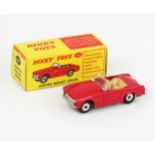 A Dinky Toys 112 Austin Healey Sprite in red with cream interior and spun hubs. Excellent in