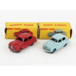 Two Dinky Toys 40j Austin (A40) Somersets, one in red with red ridged hubs, one in pale blue with