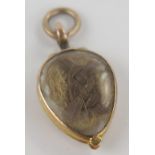 Georgian Memorial Locket in an unmarked gold setting with hinged compartment containing hair, 27mm