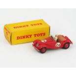 A Dinky Toys 108 MG Midget Sports in red with tan interior, red hubs RN '24', white racing driver in