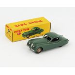 A Dinky Toys 157 Jaguar XK120 Coupe in dark sage green with fawn hubs in correct type 2 green spot
