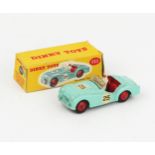 A Dinky Toys 111 Triumph TR2 Sports in turquoise, red interior and hubs, white racing driver and